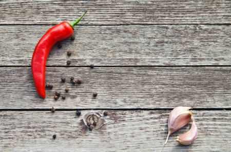 Red hot chili peppers with garlic on wooden backgroundの写真素材