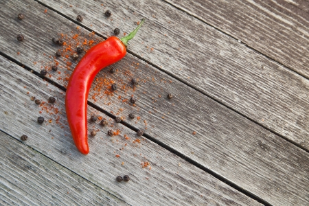 Red hot chili peppers on wooden backgroundの写真素材