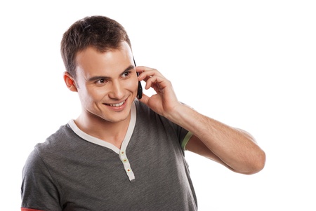 Young and healthy man answering the phone against a white backgroundの写真素材