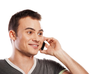 Young and healthy man answering the phone against a white backgroundの写真素材