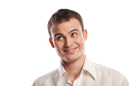 Handsome smiling young man looking up over white backgroundの写真素材