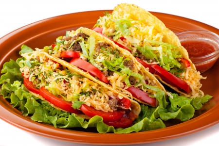 Closeup of beef tacos served with salad and fresh tomatoes salsa on white backgroundの写真素材