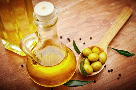 Extra virgin healthy Olive oil with fresh olives on rustic wooden backgroundの写真素材
