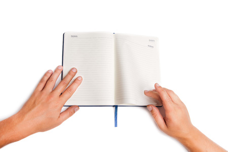 Man hand holding open book isolated on white backgroundの写真素材
