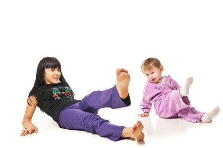 Yoga for woman and child. Mother with the baby doing exercisesの写真素材