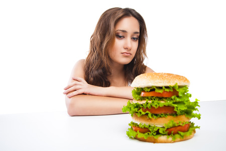 picture of healthy woman rejecting junk food isolated over white backgroundの写真素材