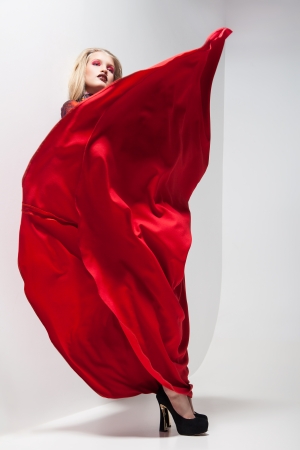 Fashion of young magnificent woman in red dress. の写真素材