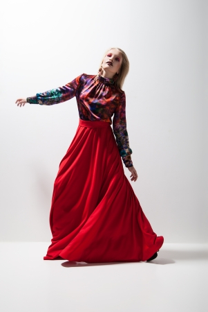 Fashion of young magnificent woman in red dress. の写真素材
