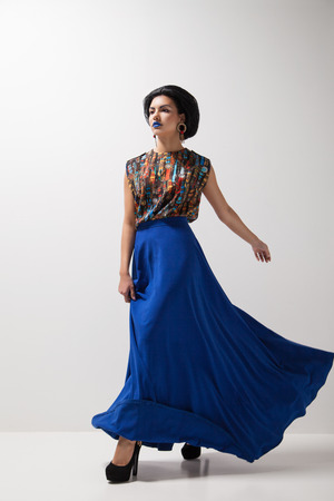 Fashion photo of young magnificent woman in blue dress. Studio photoの写真素材