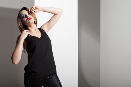 Fashion model wearing leather pants posing on white backgroundの写真素材