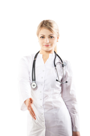 Attractive young nurse in uniform. Giving a hand for a handshake. Isolated on white backgroundの写真素材