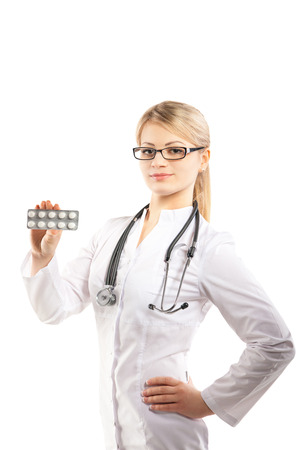Doctor woman showing pill. Young female medical professional on white backgroundの写真素材