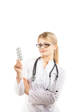 Doctor woman showing pill. Young female medical professional on white backgroundの写真素材