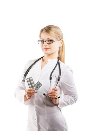 Doctor woman showing pill. Young female medical professional on white backgroundの写真素材
