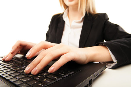 Woman hands typing on laptop, close-up, isolated over white の写真素材