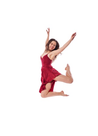Gorgeous young ballet dancer wearing red dress isolated over white backgroundの写真素材