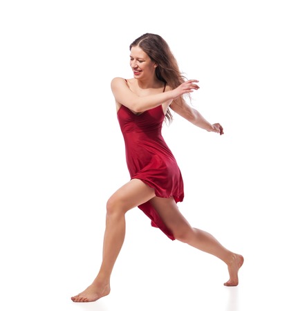Gorgeous young ballet dancer wearing red dress isolated over white backgroundの写真素材