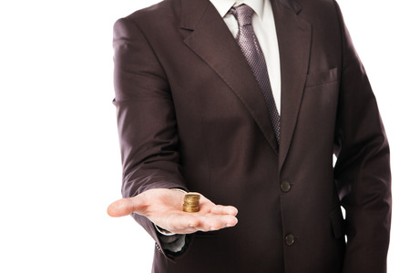 businessman holding coins in his hand isolated over whiteの写真素材