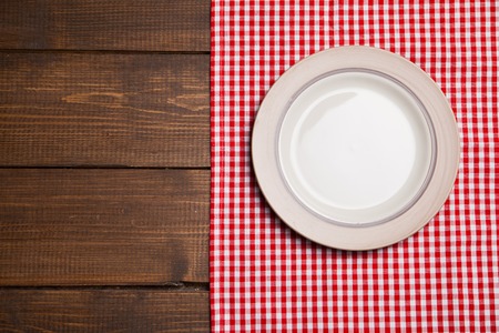 Dish on wooden table with red checked tableclothの写真素材