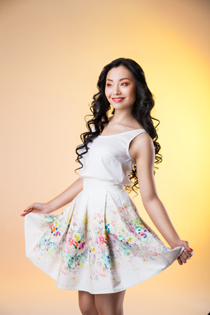 Romantic beautiful woman wearing white dress on colourful の写真素材