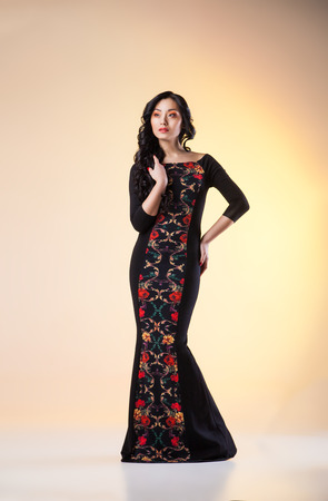 beautiful woman model posing in elegant dress in the studioの写真素材