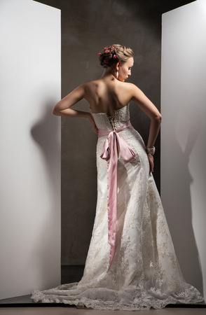 The beautiful young woman posing in a wedding dressの写真素材