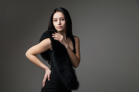 Beautiful Woman in Luxury Fur over gray backgroundの写真素材