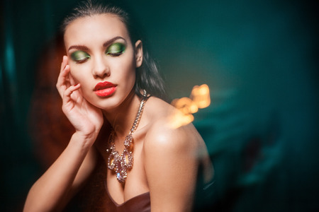 Beautiful woman with evening make-up over dark background  Jewelry and Beauty  Fashion photoの写真素材