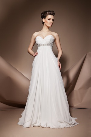 The beautiful young woman posing in a wedding dressの写真素材