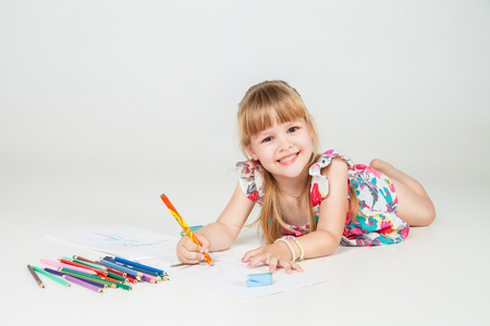 Portrait of lovely girl drawing with colorful pencilsの写真素材