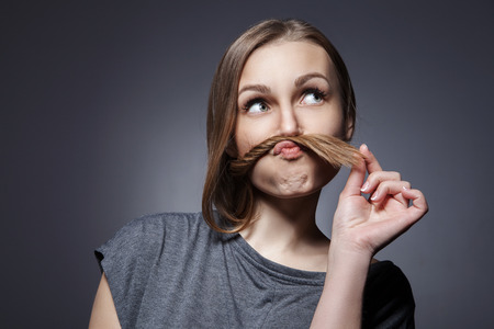 Attractive woman looking up over dark grey backgroundの写真素材