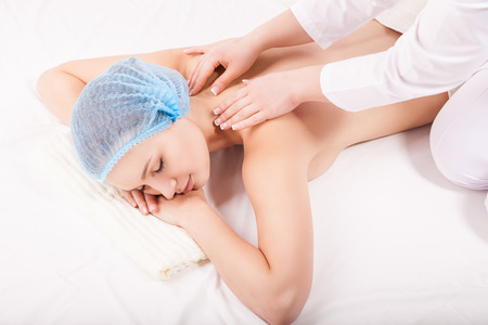 Portrait of a young woman during massage procedureの写真素材