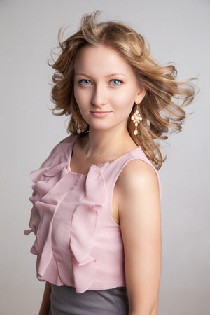 Beautiful Woman with Curly Hair over gray backgroundの写真素材