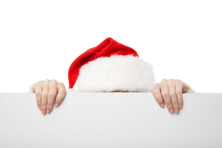 Beautiful christmas woman in santa hat holding empty board isolated on white backgroundの写真素材