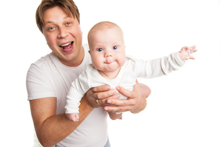 Happy young man holding a smiling baby isolated on whiteの写真素材