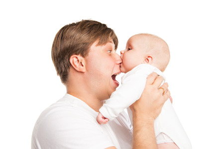 Young Caucasian father playing with baby son over white backgroundの写真素材
