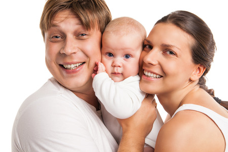 Portrait of a young happy family with the kid over white backgroundの写真素材