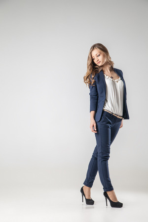 Beautiful sexy young business woman with evening make-up dressed in pants and suit business clothes for meetings and walksの写真素材