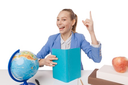 Smiling student getting inspiration. Casual beautiful girl pointing up isolated on white background.の写真素材