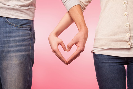 love and relationships concept -  woman and man hands showing heart shapeの写真素材