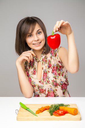 Young Woman Cooking in the kitchen. Healthy Food - Vegetable Salad. Diet. Dieting Concept. Healthy Lifestyle.  Prepare Foodの写真素材