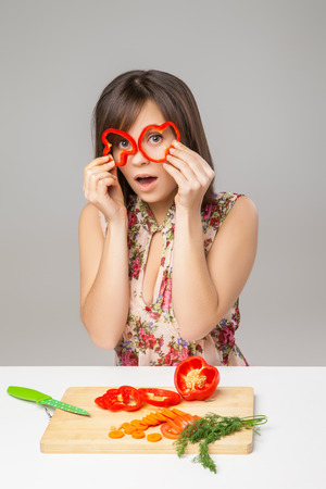 Happy and joking girl with pepper lookの写真素材