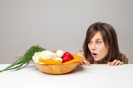 woman looking at green vegan food. surprise emotion.の写真素材
