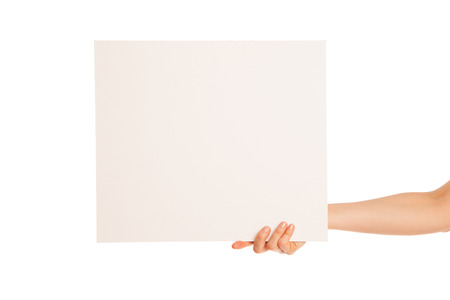 in hand a big blank sheet of white paper shown up. Isolated, over white background.の写真素材