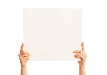 Isolated hands holding a piece of paper up over white background.の写真素材
