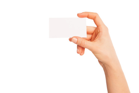 a blank sheet of white paper in hand between fingers. Hand to the left. Isolated, over white background.の写真素材