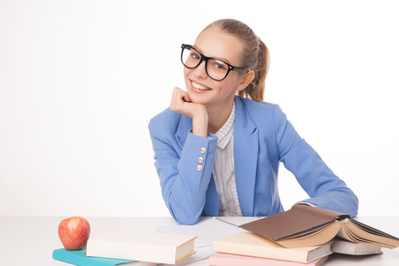 picture of smiling student with stack of books. Isolated.の写真素材