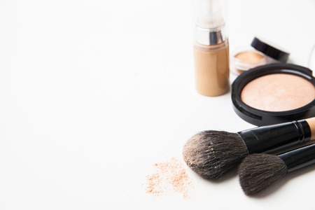 Powder, foundation and brushes isolated on the white backgroundの写真素材
