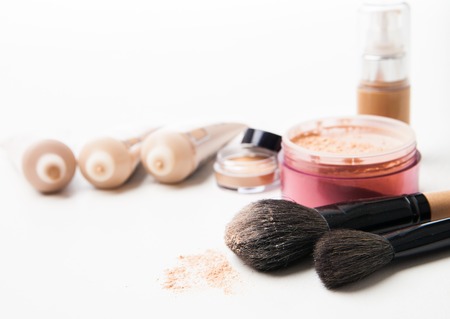 Powder can ,  tubes of foundation in a row and brushes isolated on the white backgroundの写真素材