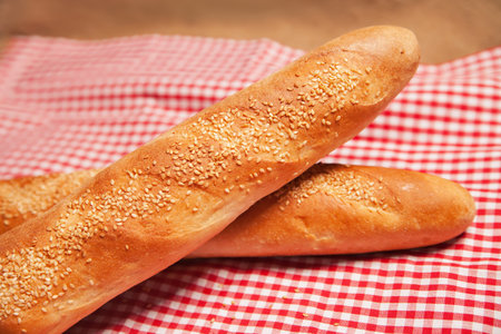 a pair of French bread isolated on checkered napkin